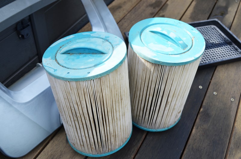 Dirty Hot tub filters sitting on a deck